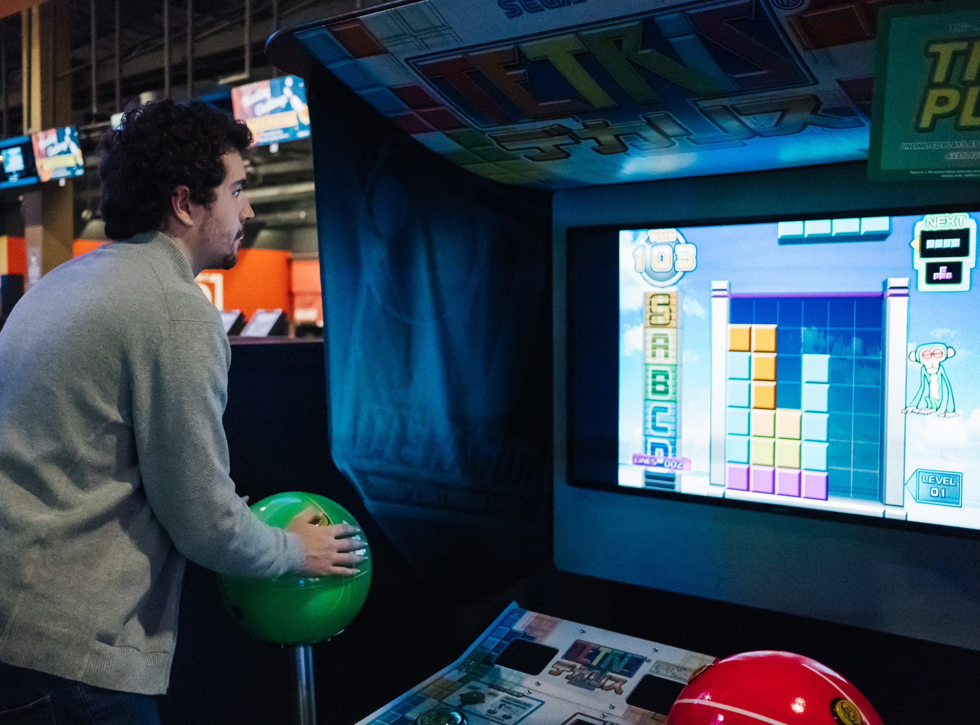 Me playing Giant Tetris at an arcade, the cabinet features two giant joysticks which I can be seen controlling one of them.