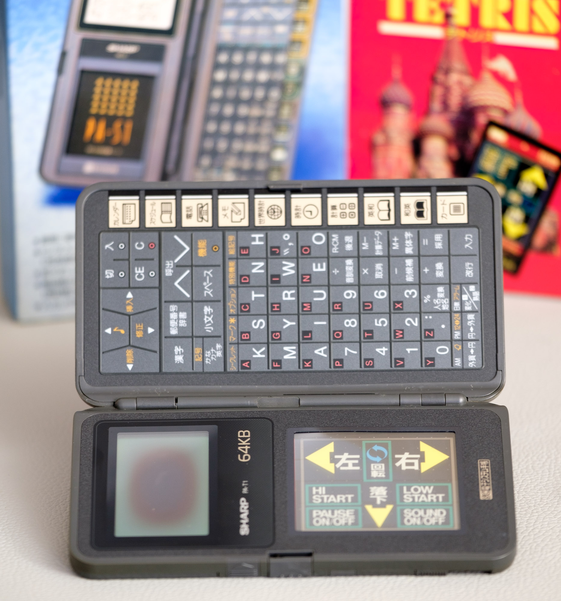 Photo of the Sharp PA-S1 opened and orientated sideways, as you would when playing the installed game Tetris.