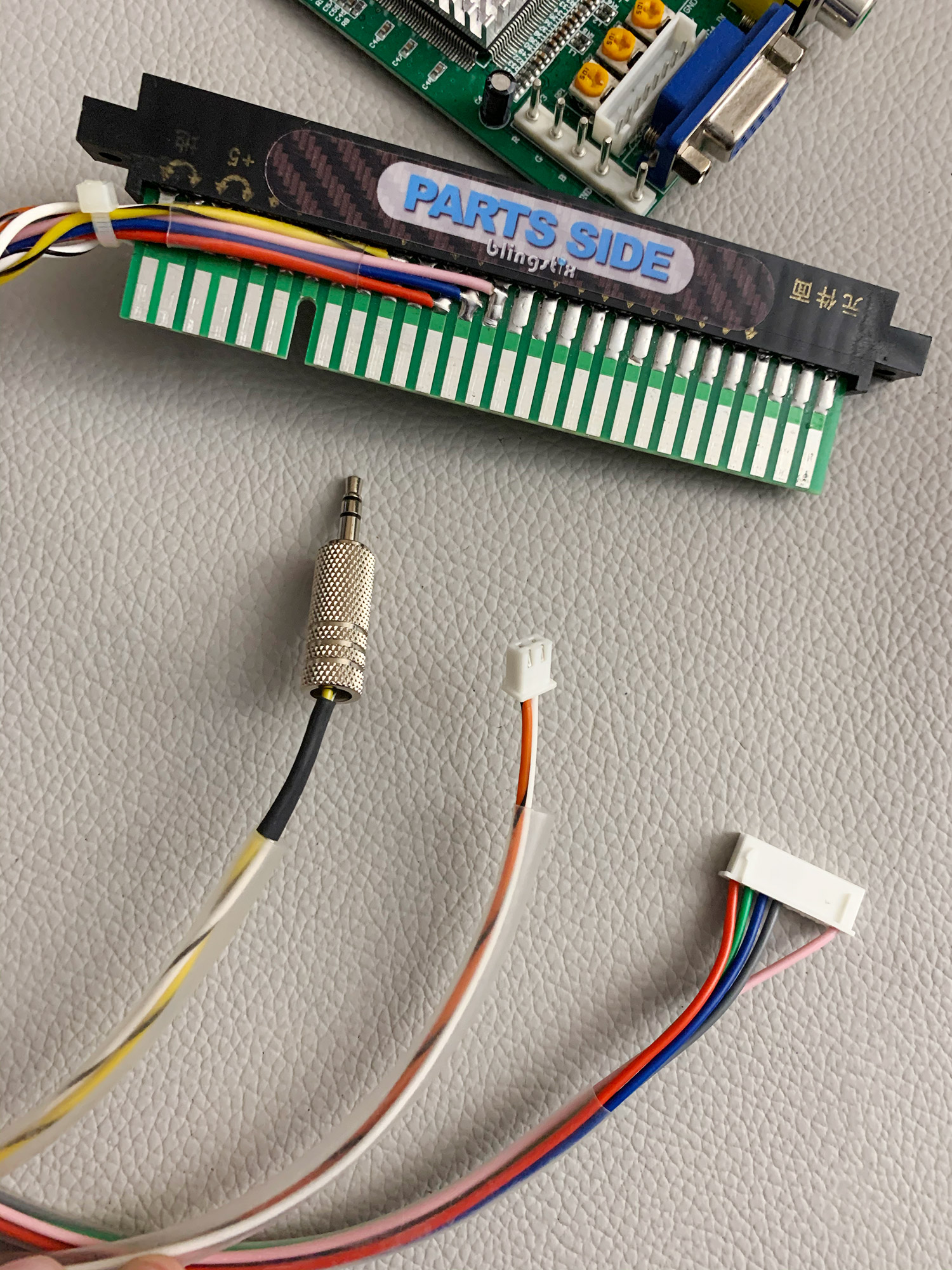 A JAMMA passthrough connector that has a video, audio, and power tap.