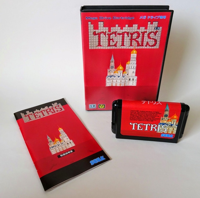 A reproduction of the game Tetris for the Mega Drive showing the case, manual, and cartridge